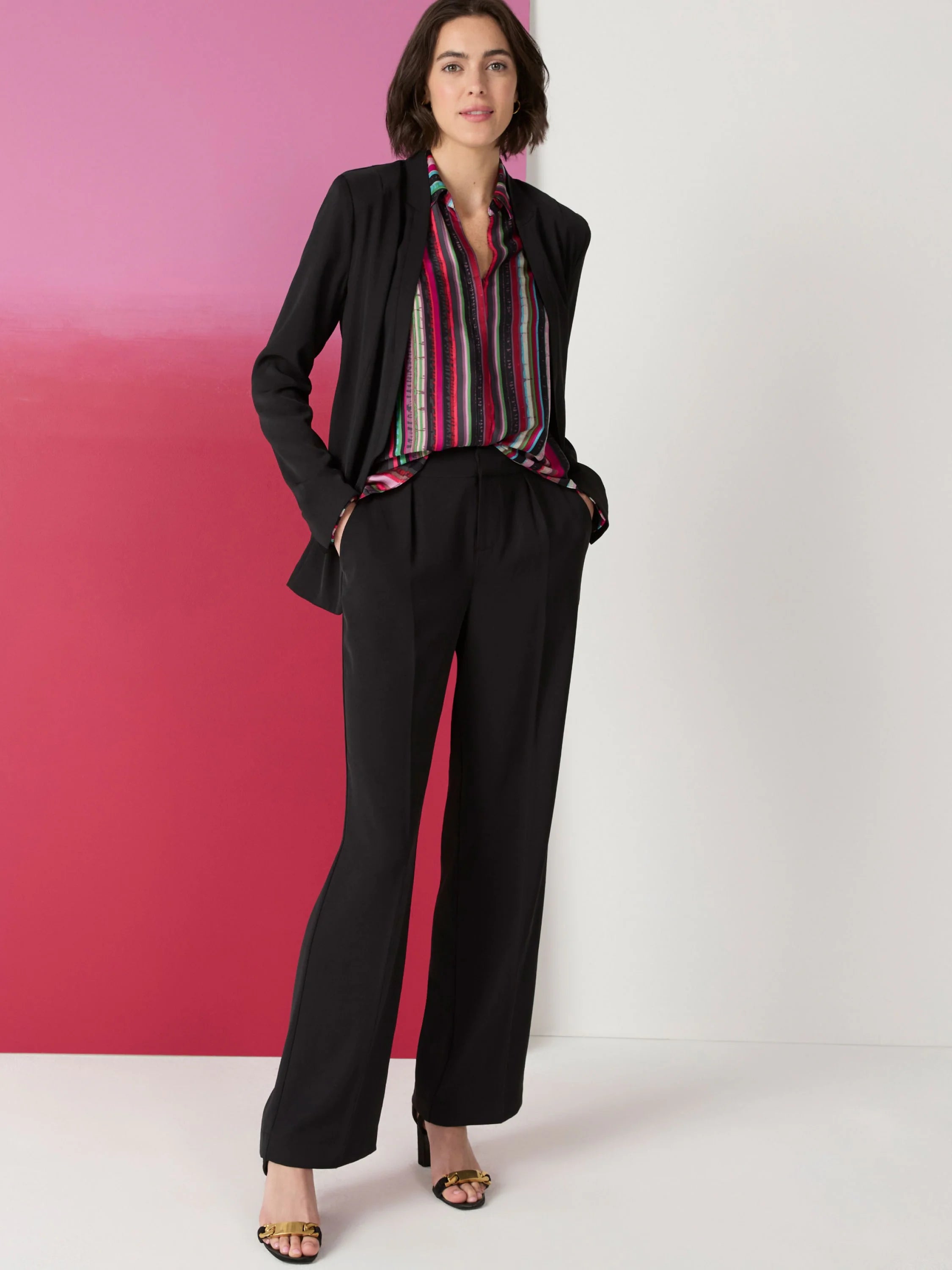 Multicolored vertical stripes on a shirt; pink, green, black, dark red.  Shirt worn under a black blazer.