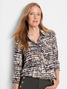 Harvest Dot Top: Black, beige, brown, light blue, and olive abstract dot collared shirt.