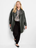 White, black, blue, and tan abstract dot pattern long-sleeve blouse.