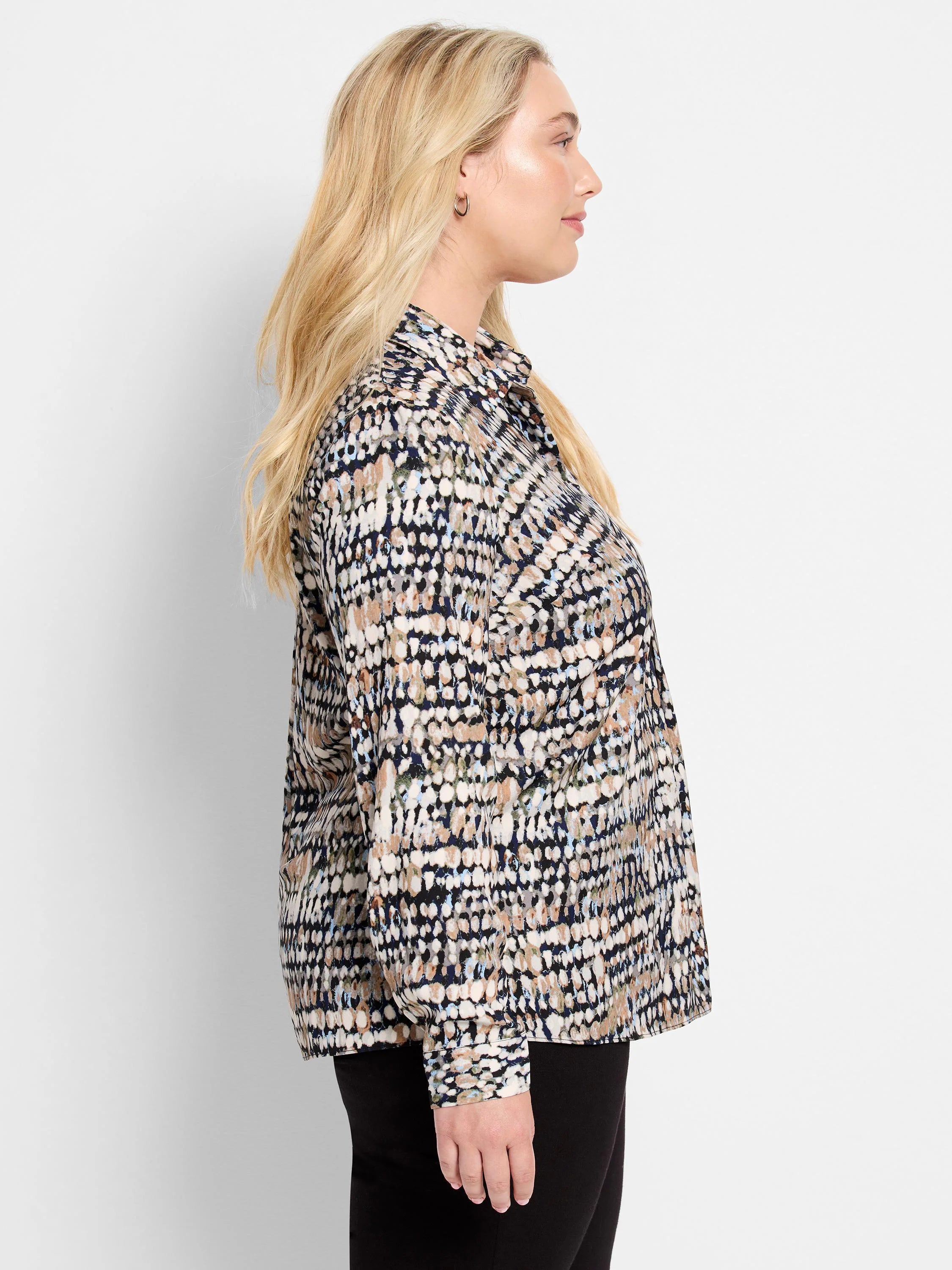 Collared shirt with an abstract cream, black, tan, light blue, and olive green dot pattern. Long sleeves with buttoned cuffs.