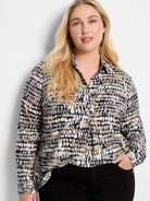 Harvest Dot Top: Collared, long-sleeve shirt with an abstract pattern of cream, navy, tan, and light blue dots.