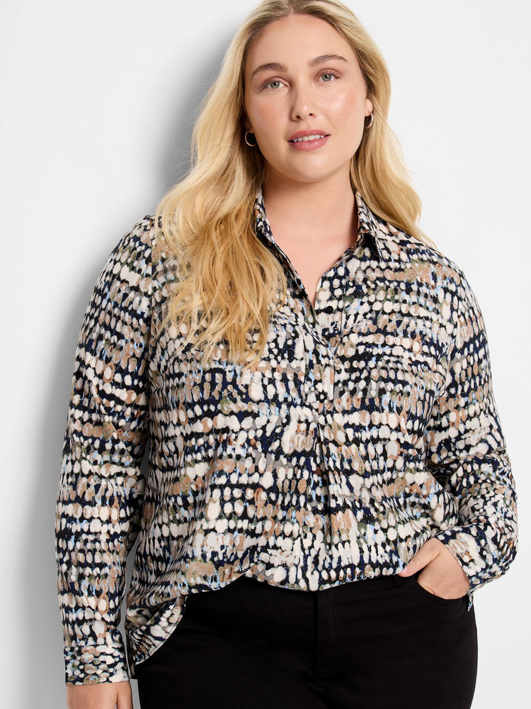 Collared shirt with an abstract dot pattern in navy, cream, brown, light blue, and olive green.