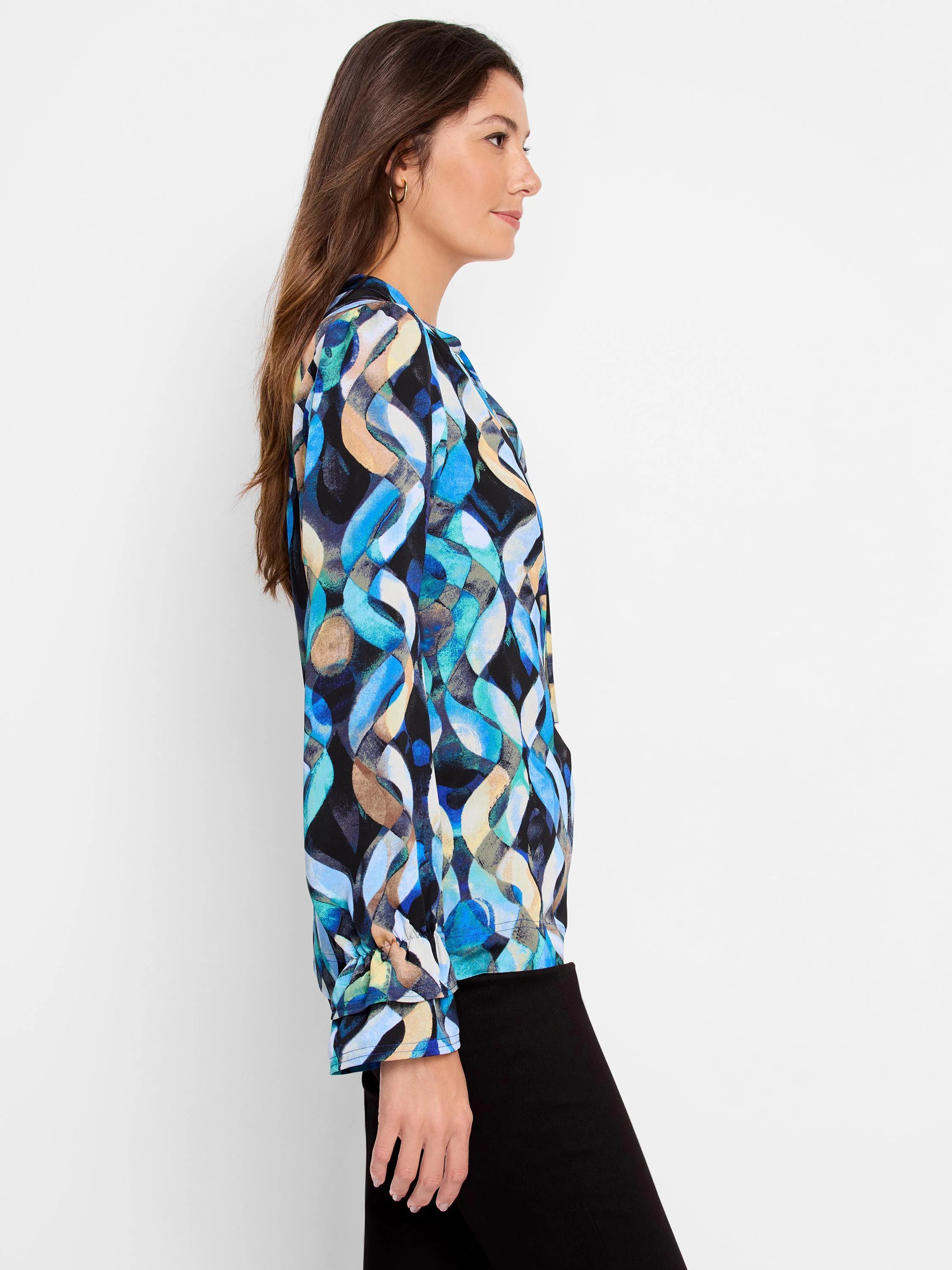 Long-sleeve blue, teal, beige, and black abstract print top.  The print features wave-like patterns.