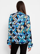 Long-sleeve top, blue, teal, and beige abstract print on black background.  Ruffled cuffs.