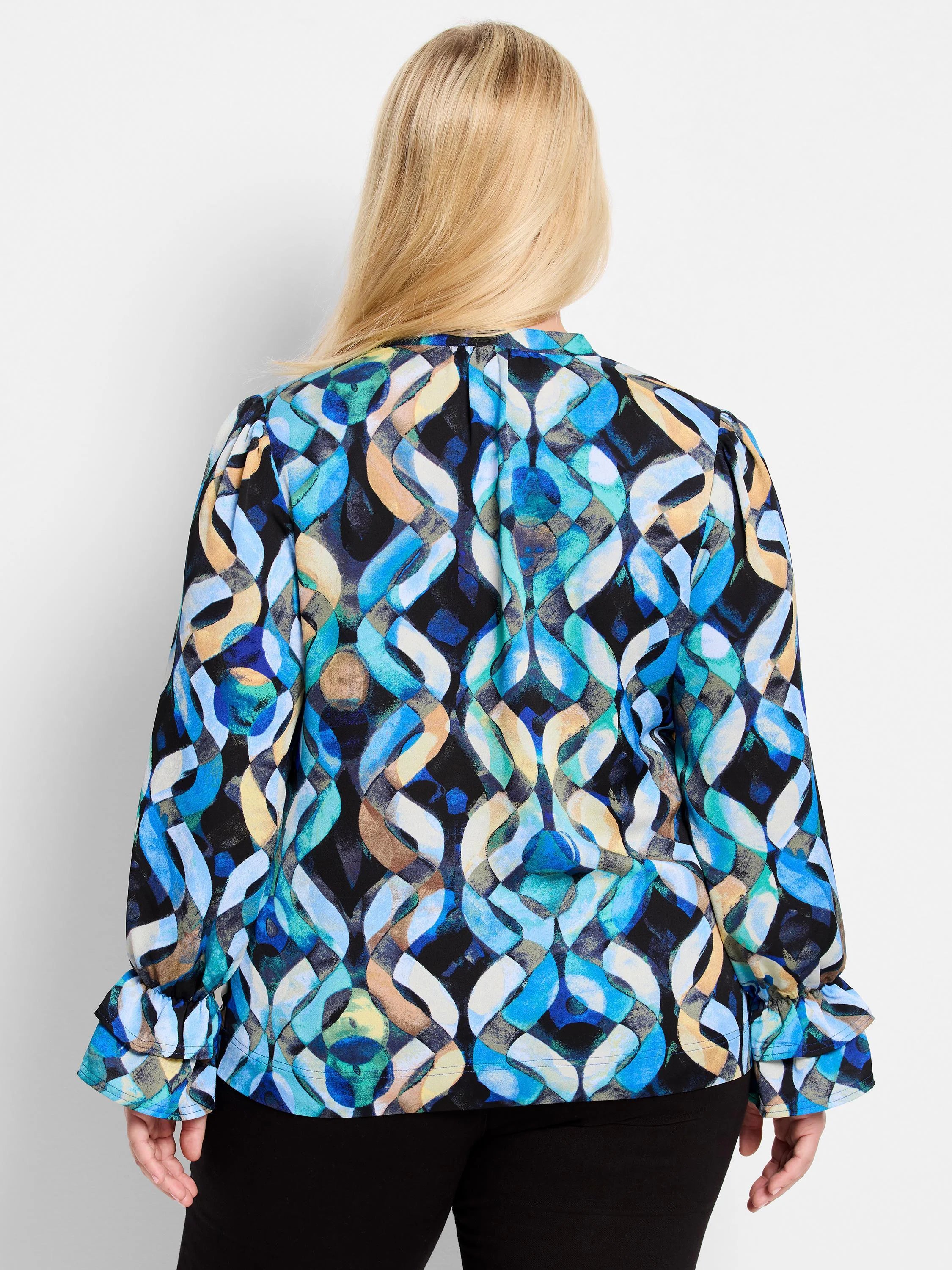 Blue, teal, beige, and black abstract print long-sleeve top with ruffled cuffs.