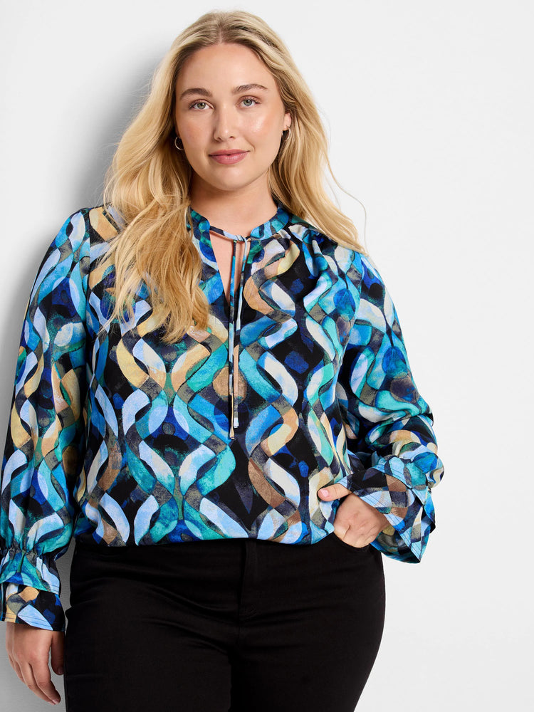 Long-sleeve, blue, teal, and beige patterned top with keyhole neckline and tie.  Features an abstract wavy design on a...