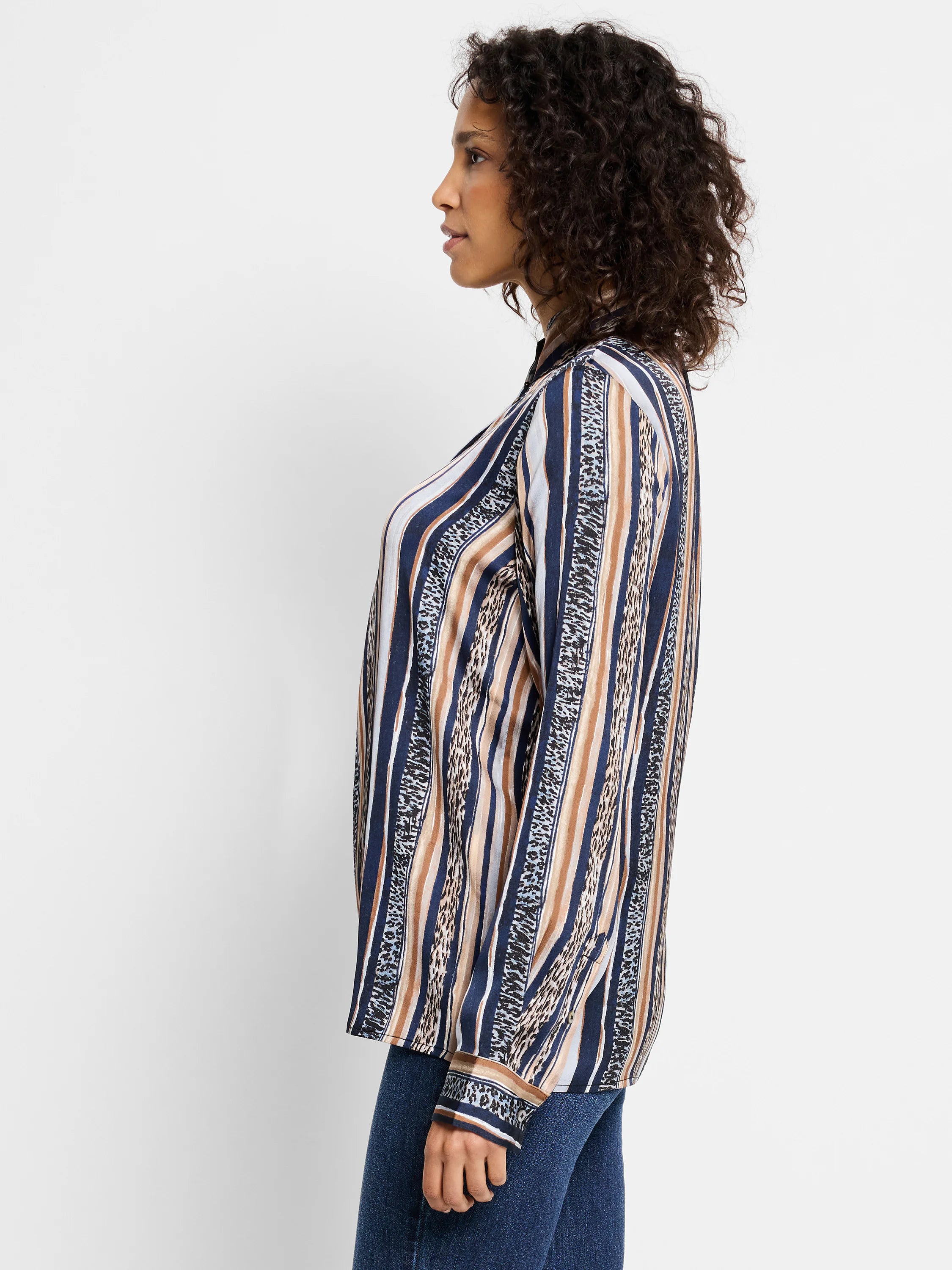 Long-sleeved shirt with vertical stripes in navy, tan, and light gray.  Some stripes incorporate a light animal print.
