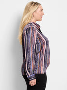 Long-sleeve button-up shirt. Vertical stripes in dark purple, pink, orange, and green, with animal print accents.