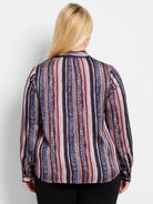 Purple, pink, orange, and green vertical stripes with a subtle animal print.  Long sleeves, button cuffs.