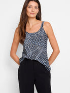 Sleeveless cami with scoop neck.  Black, white, and blue geometric print on a light background.