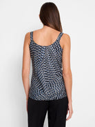 Black cami with an abstract, geometric print in shades of blue, white, and beige.  Sleeveless, scoop neck.