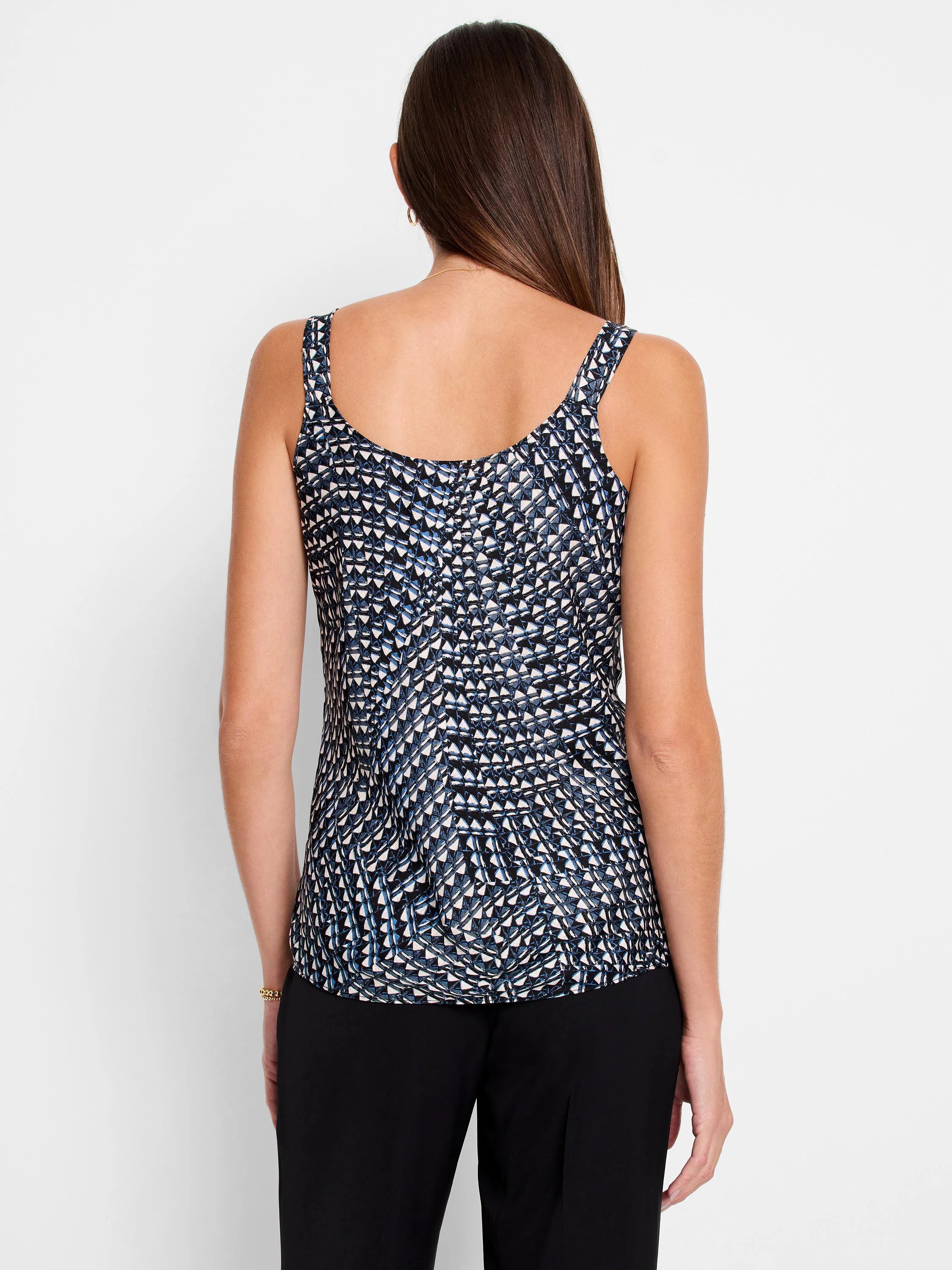 Black cami with an abstract, geometric print in shades of blue, white, and beige.  Sleeveless, scoop neck.