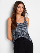 Sleeveless cami with scoop neck. Dark blue, white, and light blue geometric print on a black background.
