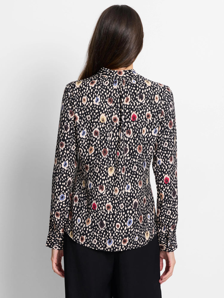 Black long-sleeve top with multicolored spotted pattern.  Beige, brown, blue, and red spots on a dark background.
