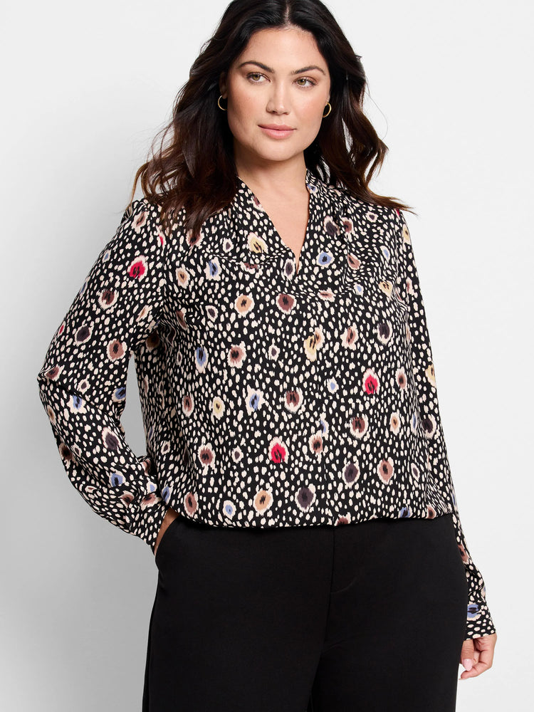 Black long-sleeve blouse.  Multicolored spotted pattern includes beige, red, brown, and blue. V-neck.