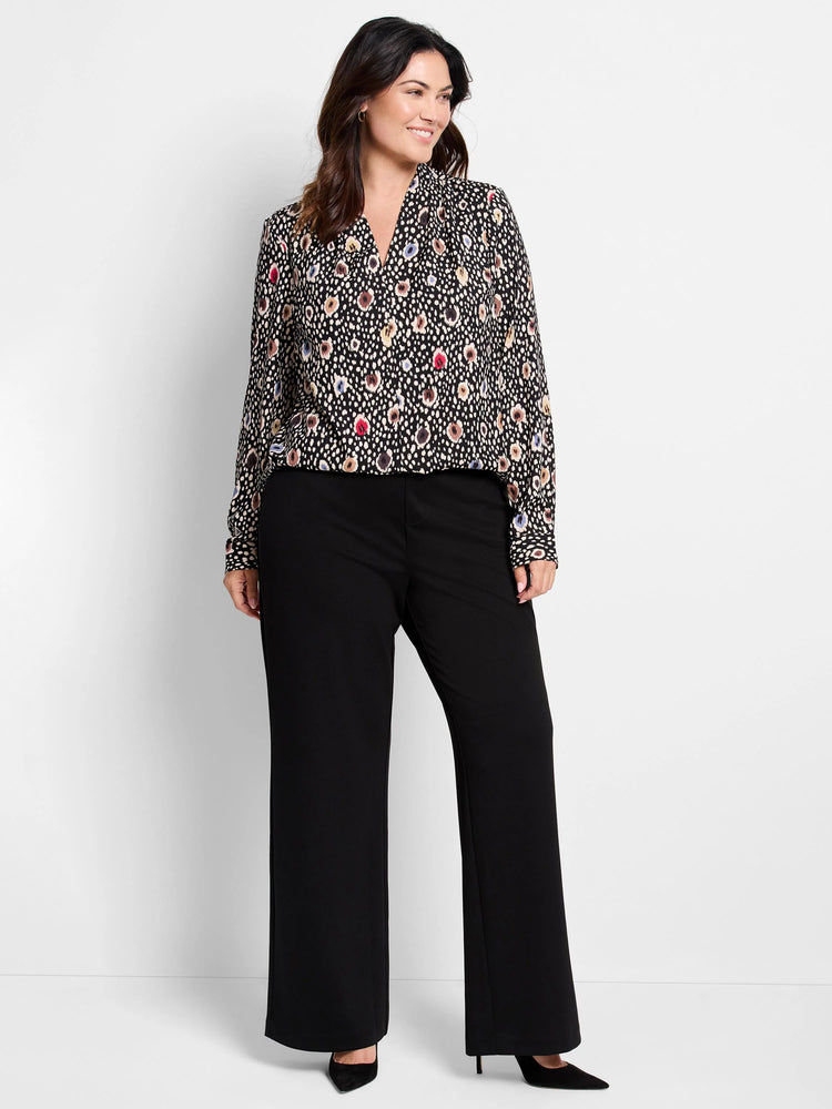 Black long-sleeve blouse with multicolored spotted pattern.  V-neck.