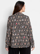Black long-sleeve blouse.  Features a multicolored spotted pattern in beige, brown, red, and blue on a black background. ...