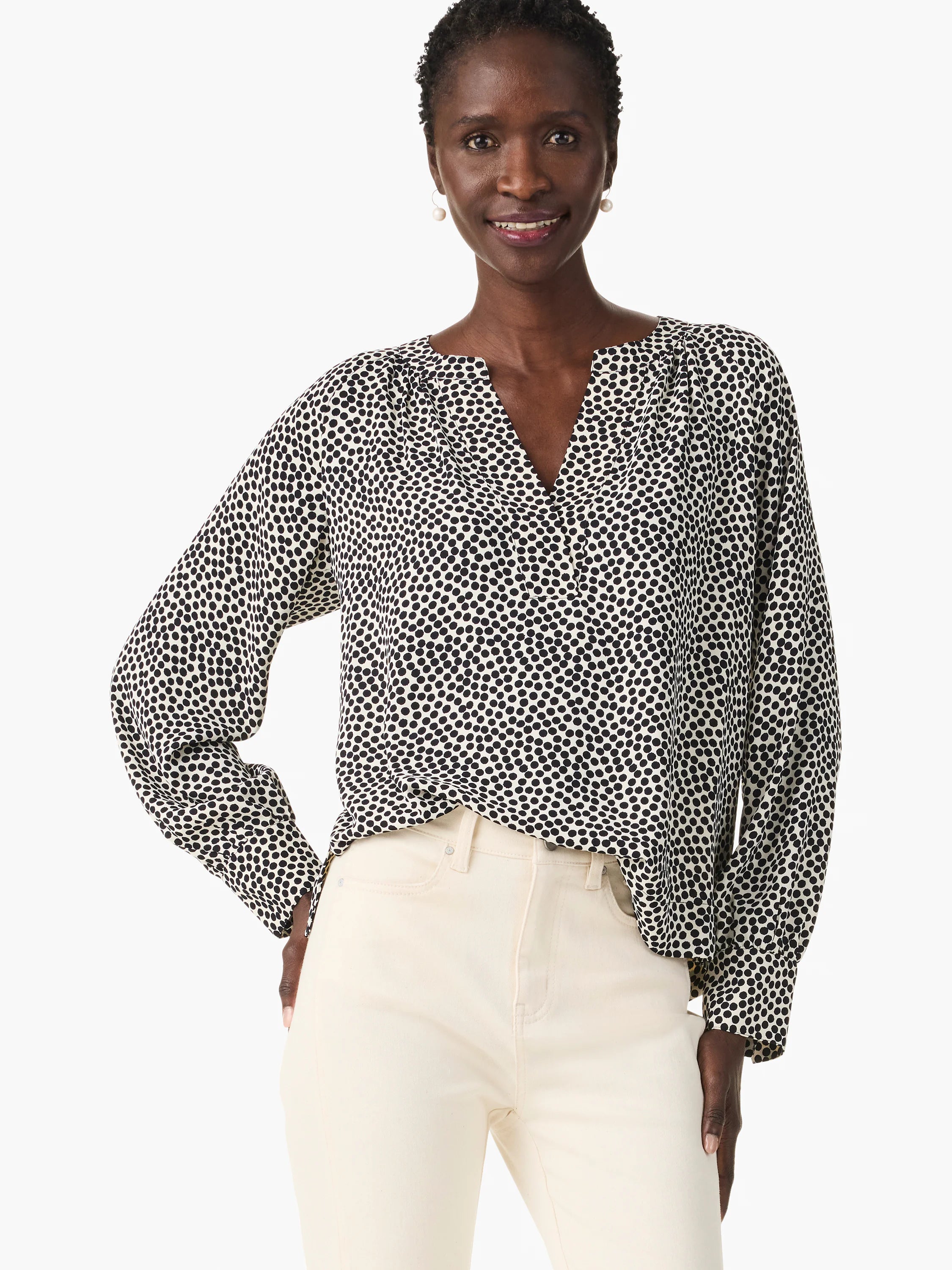 Off-white long-sleeve blouse with dark-blue polka dots, V-neck.