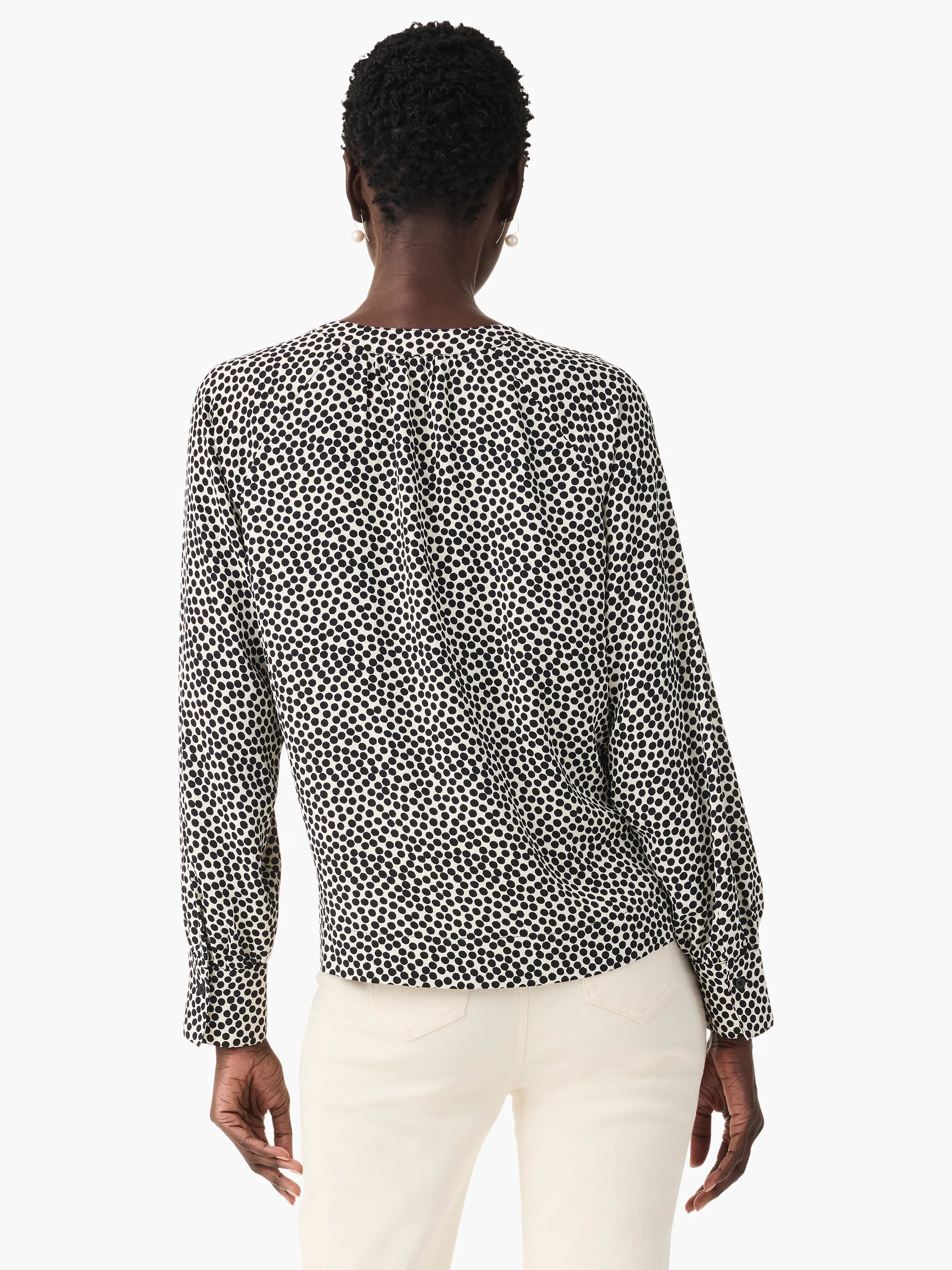 Beige top with dark-brown polka dots, long sleeves, and a V-neck.