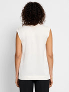 Off-white sleeveless satin jacket;  straight hem.  Rear view.