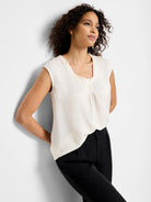 Off-white sleeveless satin top with a cowl neck.