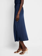 Navy blue midi slip skirt; A-line shape.