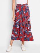 Red midi skirt with pleated blue and purple leaf print.