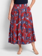 Red midi skirt with pleated front, blue and purple leaf print.