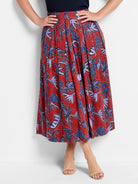 Red midi skirt with pleated blue and purple leaf print.