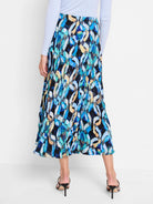 Midi pleated skirt; blue, teal, black, and beige abstract print.