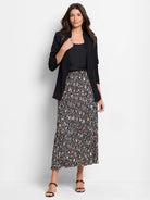 Black pleated midi skirt with multicolored spotted pattern.  Cream, beige, blue, and red spots on black.