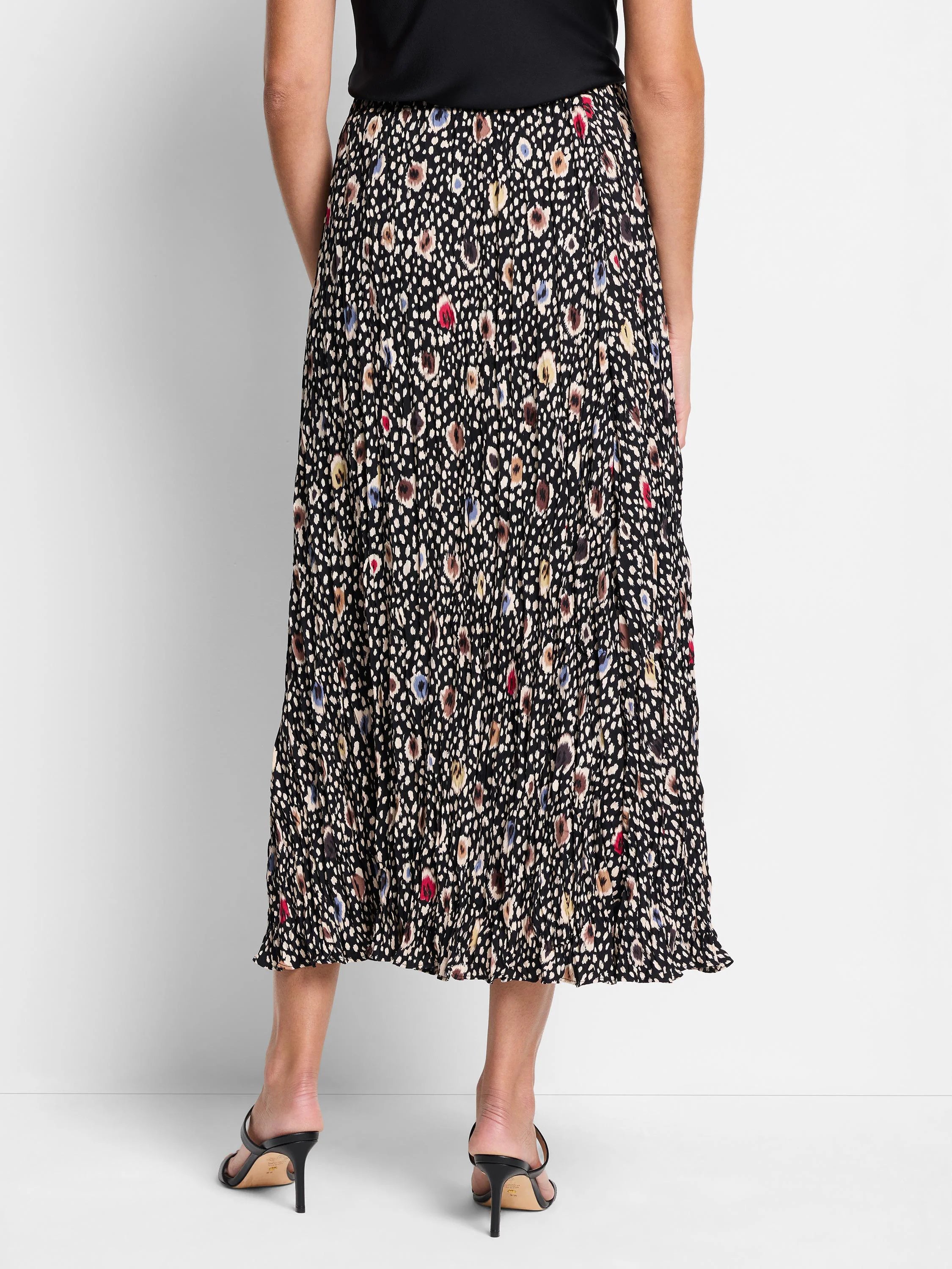 Black pleated midi skirt with multicolored spotted pattern.  Beige, brown, blue, and red spots.