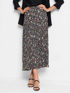 Black pleated midi skirt with beige, brown, blue & red spotted pattern.
