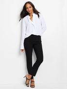 Black slim-leg pants on a model.  The pants are ankle-length.