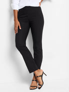 Black slim-leg pull-on pants.  Center seam detail. Model wearing shoes, shown for context.