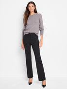 Black boot-cut pants on a model; gray sweater.