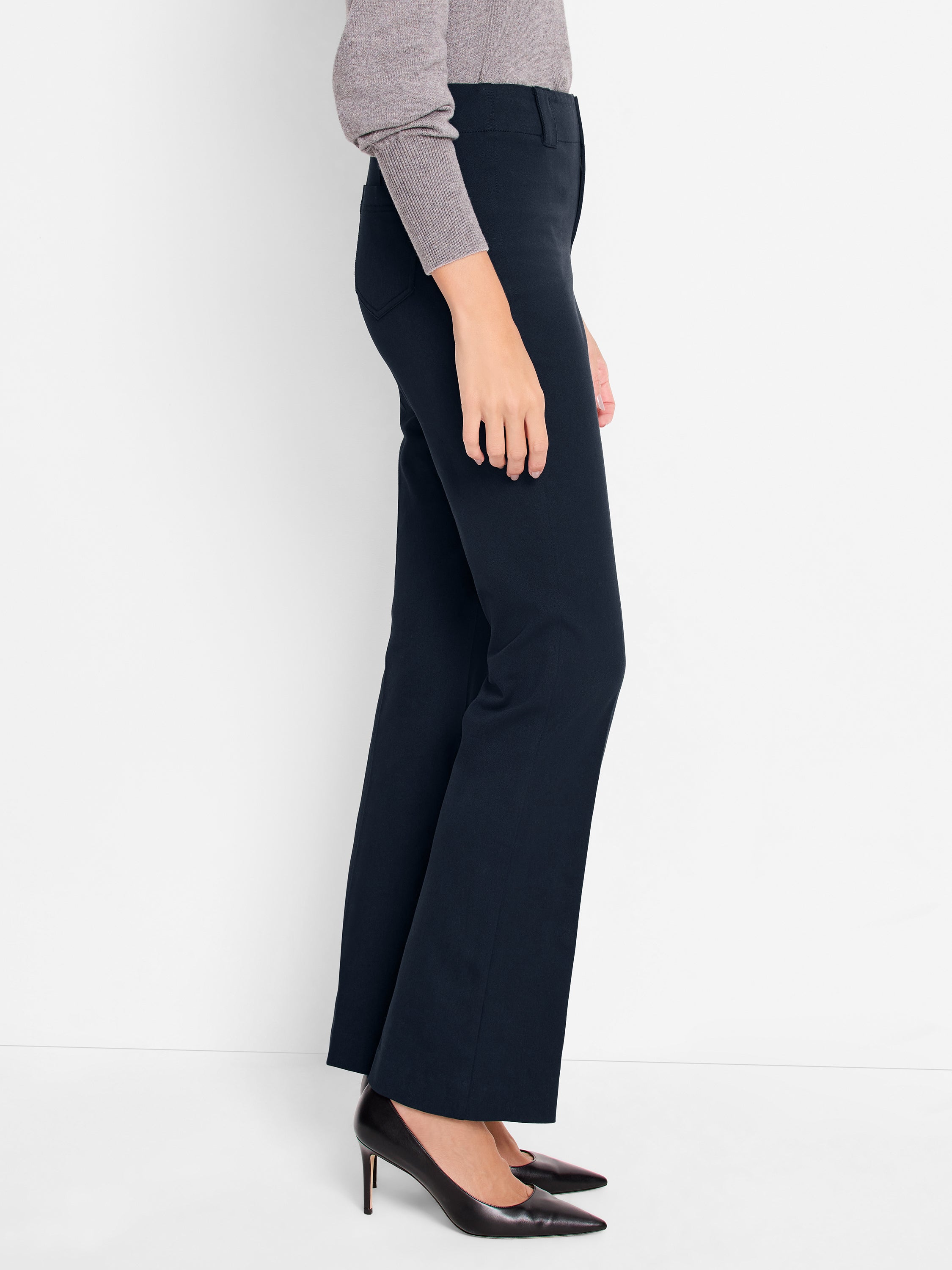 Tailored navy dress pants feature a slim fit through the hip and thigh, ending in a subtle bootcut leg.