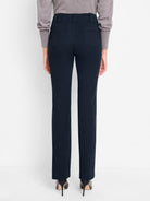 Dark navy tailored straight-leg trousers are shown from the rear, featuring prominent belt loops and angular back pockets.