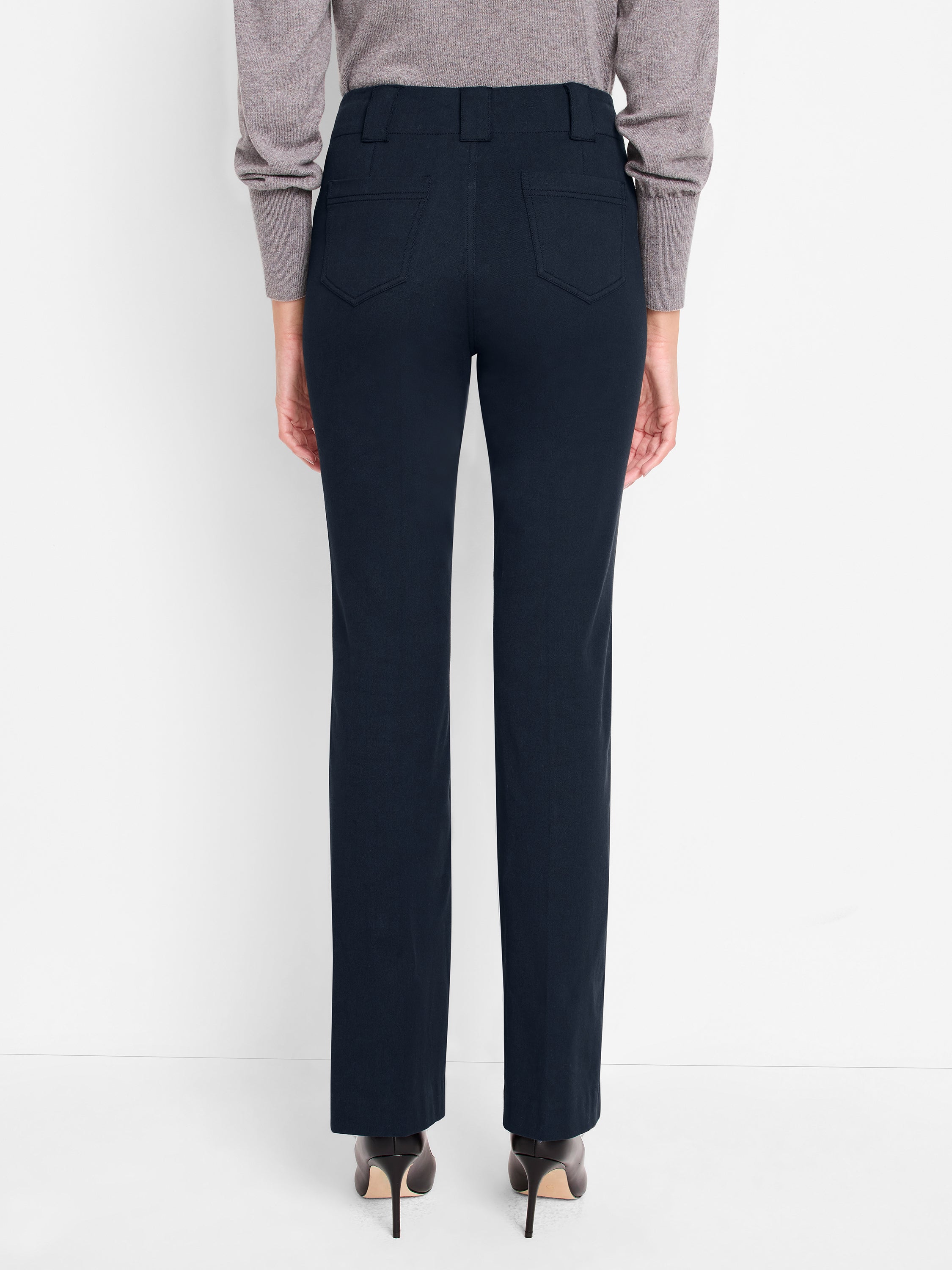 Dark navy tailored straight-leg trousers are shown from the rear, featuring prominent belt loops and angular back pockets.