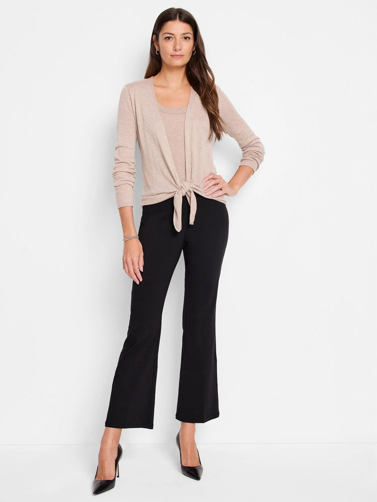 Black bootcut pants on a model.  The pants have a slight flare at the ankle.