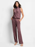 Mauve wide-leg pants; satin fabric; model shown wearing them with a mauve top and gold sandals.