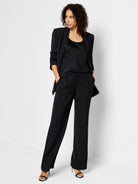 Black wide-leg trousers; model wears a black top and jacket.  Pleated front.