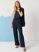Navy blue wide-leg trousers, shown on a model.  High-waisted with a straight leg.