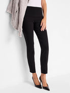 Black pull-on pants, slim fit, cropped length.  Model wears black heels.