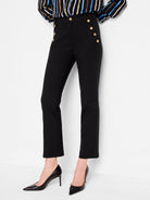 Black cropped pants with gold buttons, shown on a model.