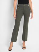 Olive green cropped pants with gold buttons and a slight bootcut. Model wears black heels.