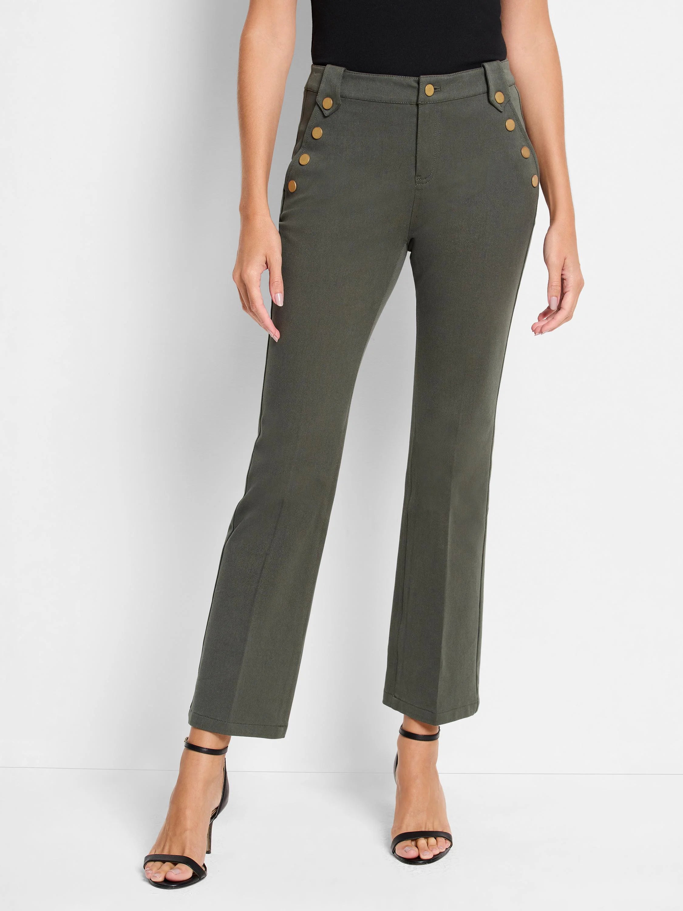 Olive green cropped pants with gold buttons and a slight bootcut. Model wears black heels.