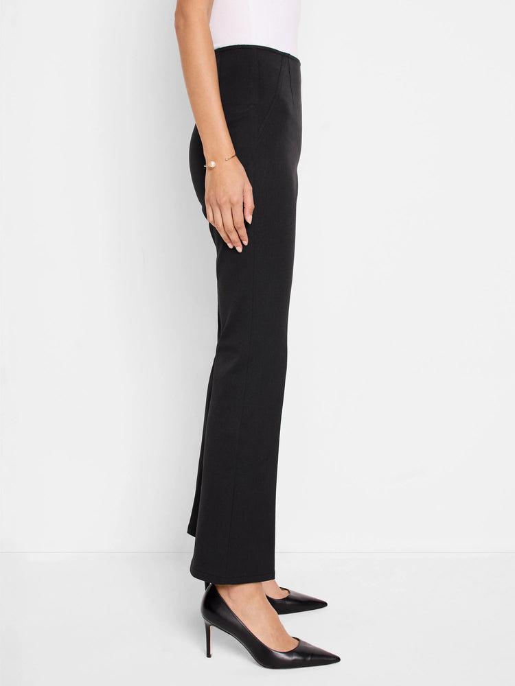 Black bootcut pants shown on a model.  The pants have a mid-rise waist.