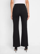 Black bootcut pull-on pants; rear view.  Slight flare at hem.