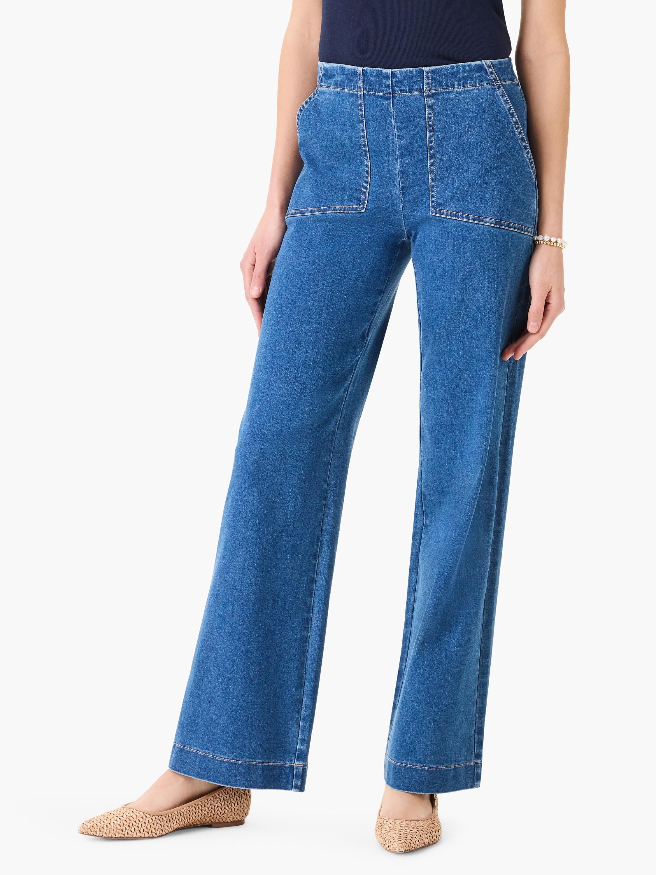 Medium blue wide leg denim with front patch pockets and light brown contrast stitching.